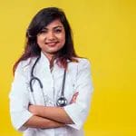 female indian young beautiful blond woman gynecologist doctor using stethoscope white medical coat yellow background 161493178