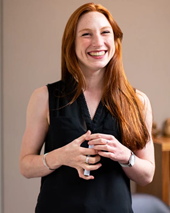 smiling woman with afro posing pink sweater 1 1