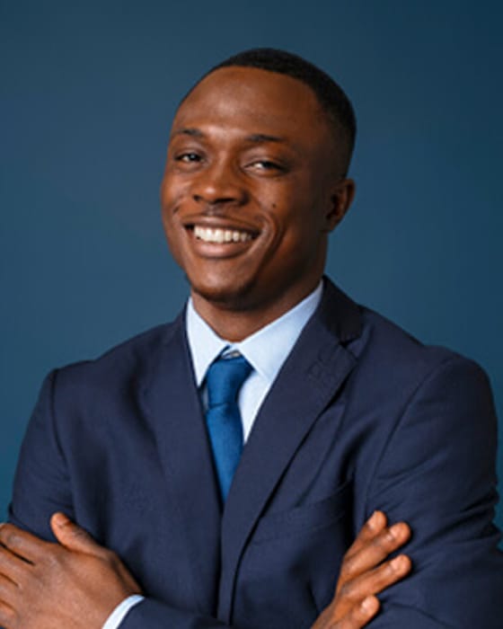 smiling woman with afro posing pink sweater 1 2