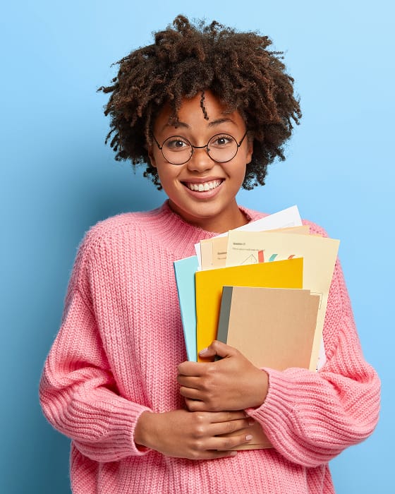 smiling woman with afro posing pink sweater 1